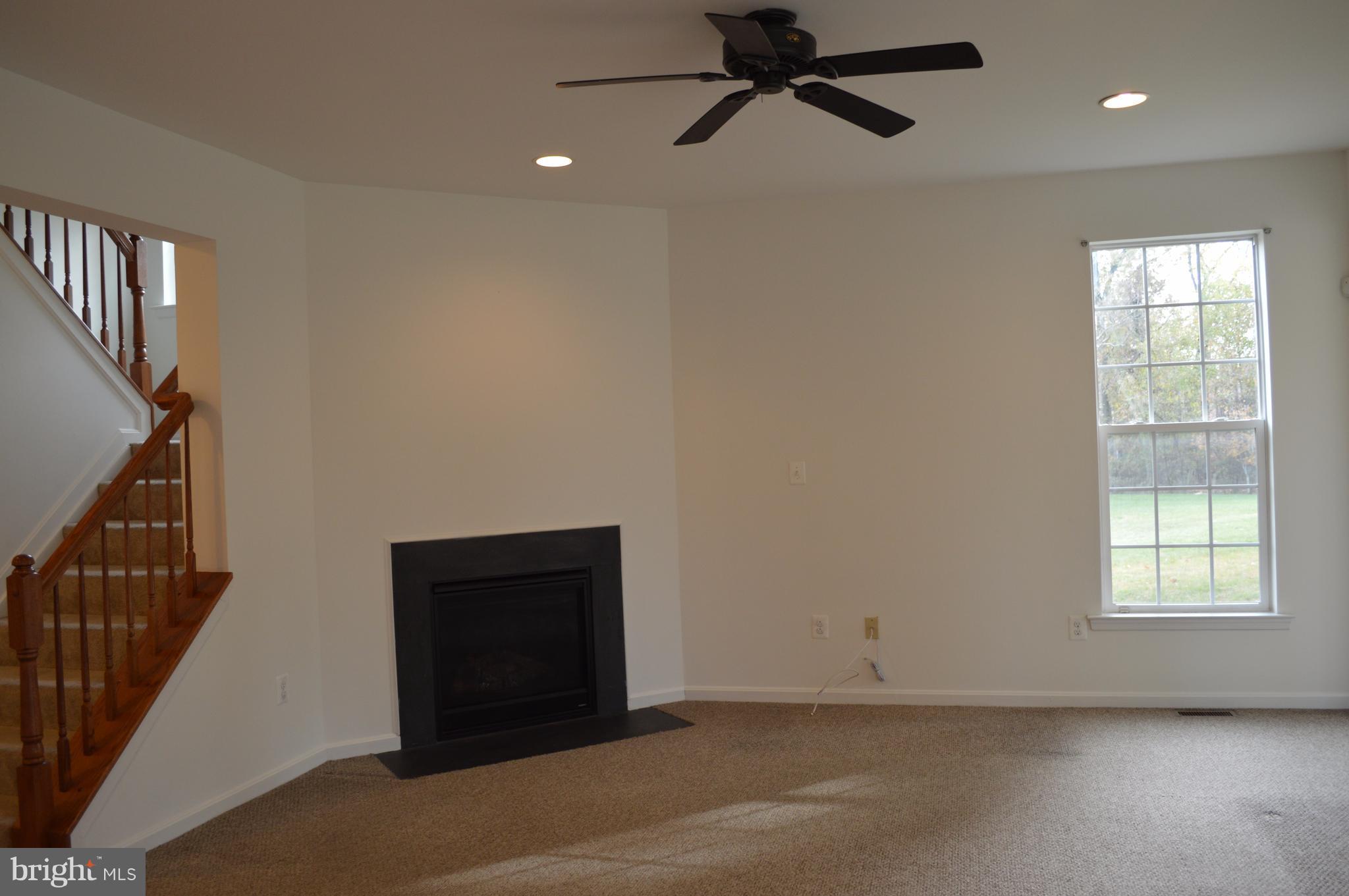 6500 Clarington Road Baltimore, MD 21209 - Photo 10 of 30 a view of an empty room with wooden floor and a window