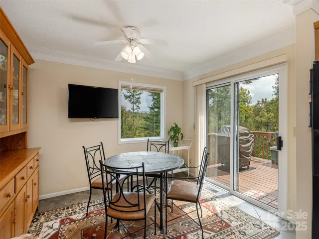 a view of a dining room with furniture and a flat screen tv