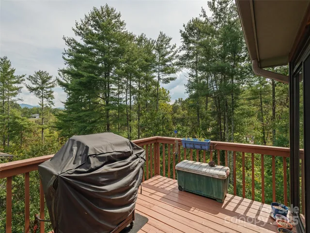 a view of a balcony with wooden floor and outdoor seating
