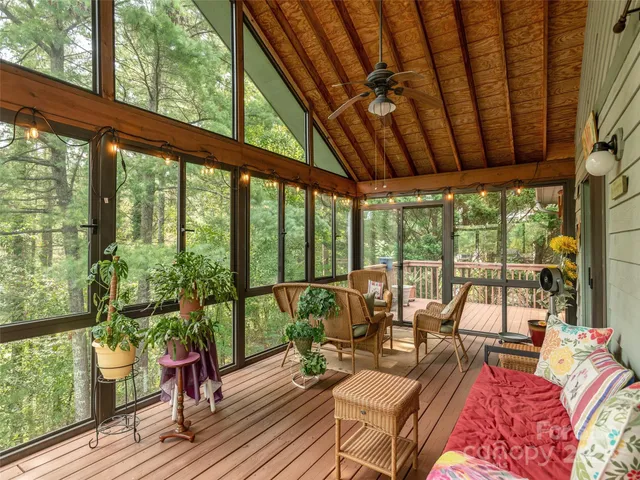 a living room with furniture and floor to ceiling windows