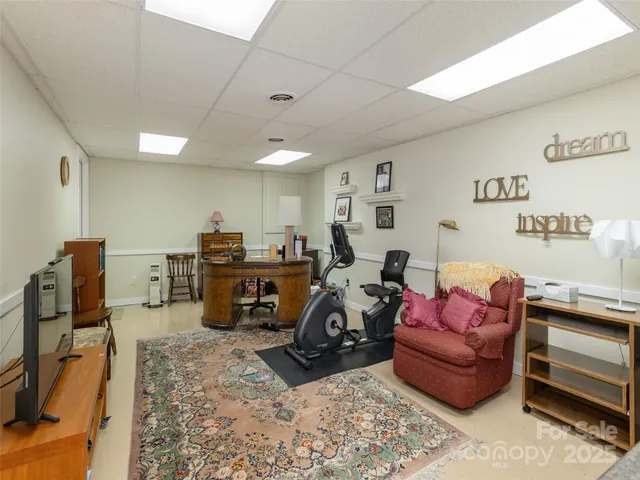 a living room with furniture a flat screen tv and a dresser
