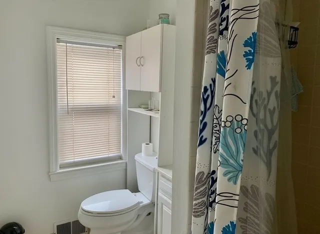 a white toilet sitting next to a bathroom sink
