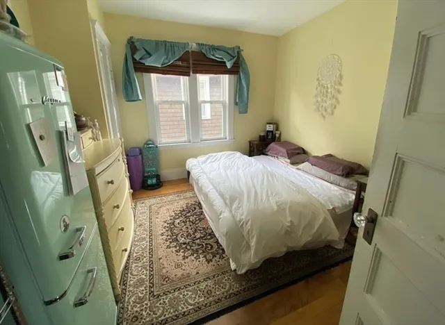 a bed sitting in a bedroom next to a window