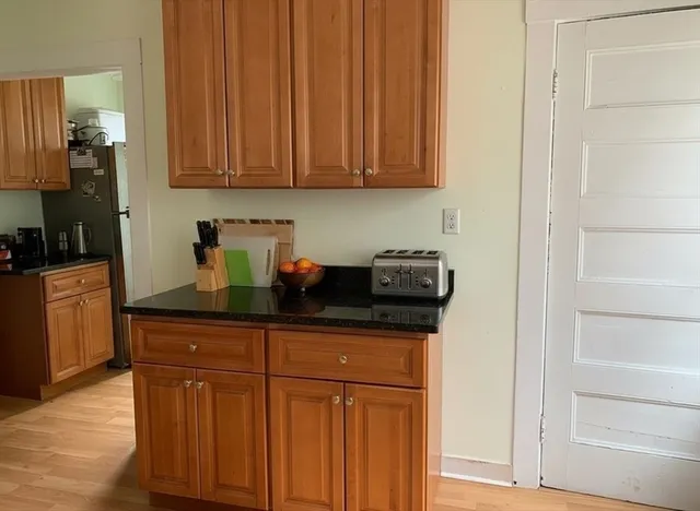 a kitchen with stainless steel appliances granite countertop a refrigerator and cabinets