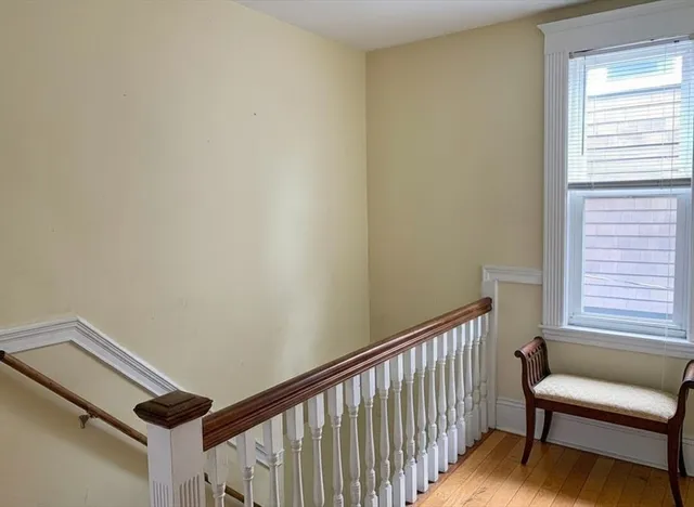 a view of a hallway with furniture