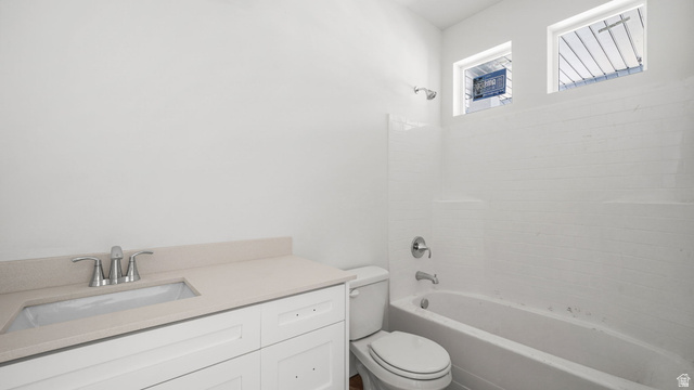 717 South Harrison Drive West Springville, UT 84663 - Photo 14 of 31 Crisp white bathroom featuring a vanity with an integrated sink and quartz-finish countertop, a tub-shower combination with subway tile surround, and dual upper windows