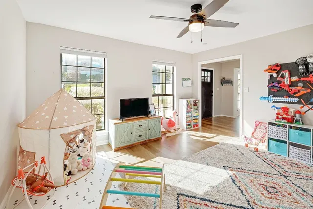 a bedroom with furniture and a flat screen tv