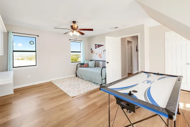 a bedroom with a bed and a chandelier