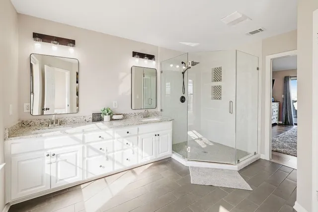 a spacious bathroom with a granite countertop sink mirror and a