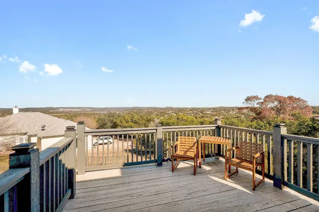 a view of roof deck with two chairs and wooden floor