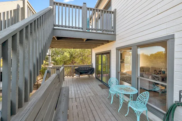 a view of a patio with table and chairs and wooden floor