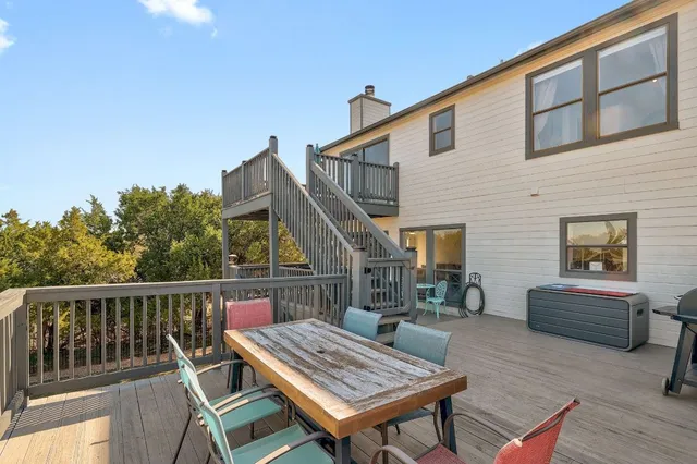 a roof deck with a table and chairs