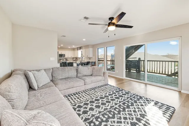 a living room with a couch and a view of kitchen