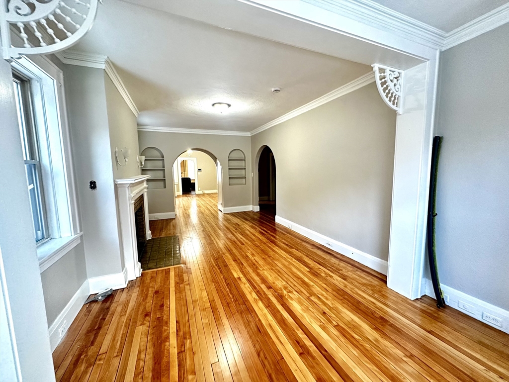 577 Pleasant Street, Unit 1L Holyoke, MA 01040 - Photo 11 of 24 a bedroom with a bed and wooden floor