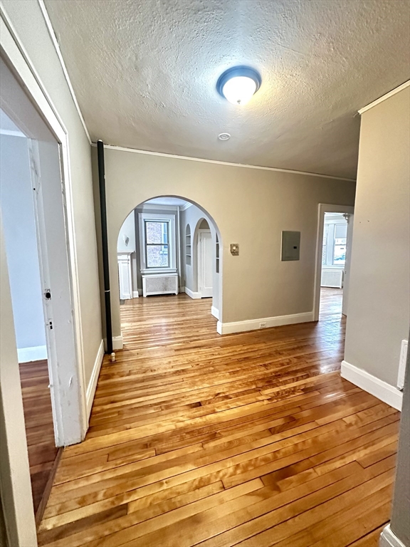 577 Pleasant Street, Unit 1L Holyoke, MA 01040 - Photo 16 of 24 a view of empty room with window and wooden floor
