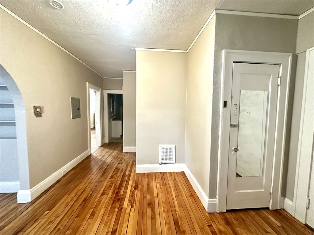577 Pleasant Street, Unit 1L Holyoke, MA 01040 - Photo 17 of 24 a view of a room with wooden floor and a bathroom