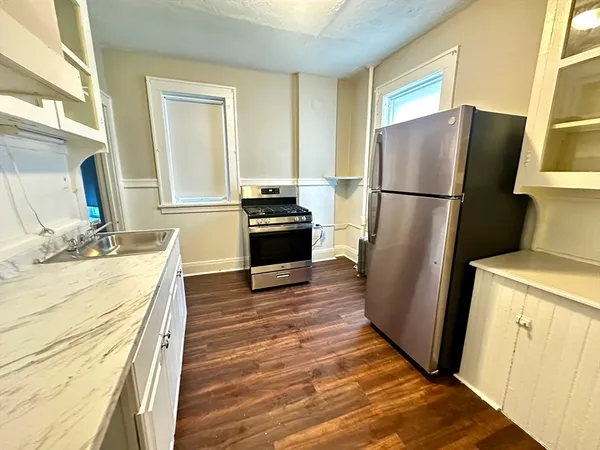 a kitchen with a refrigerator sink and stove