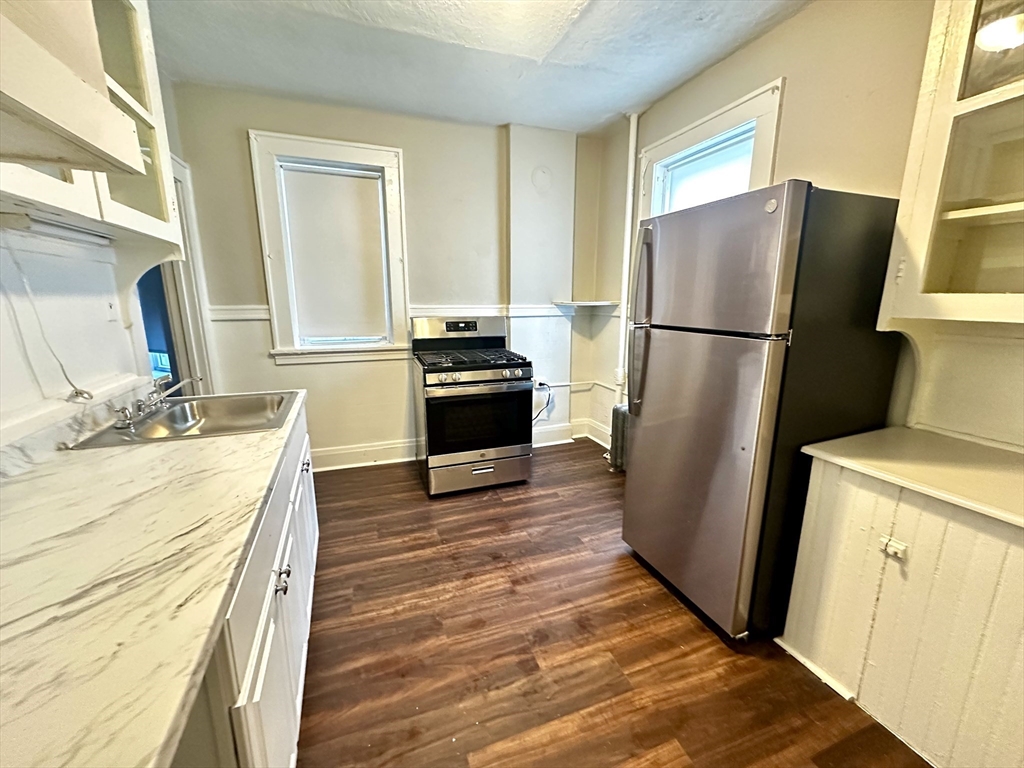 577 Pleasant Street, Unit 1L Holyoke, MA 01040 - Photo 2 of 24 a kitchen with a refrigerator sink and stove