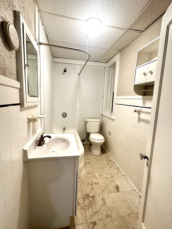 577 Pleasant Street, Unit 1L Holyoke, MA 01040 - Photo 21 of 24 a bathroom with a sink toilet and shower