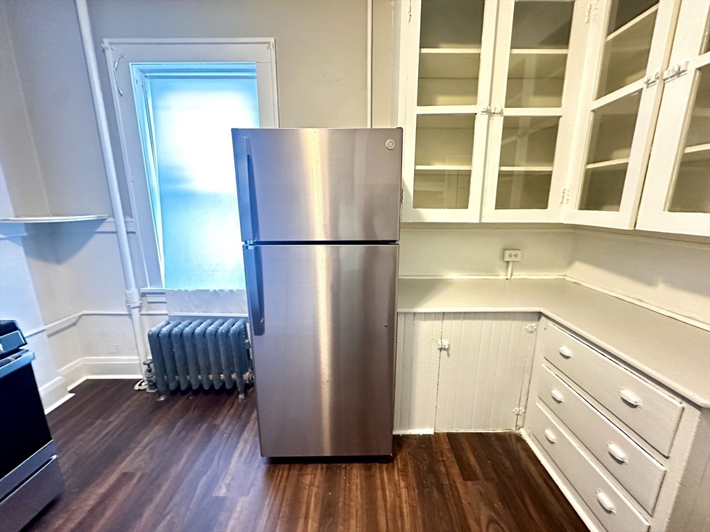 577 Pleasant Street, Unit 1L Holyoke, MA 01040 - Photo 4 of 24 a kitchen with a refrigerator and a sink