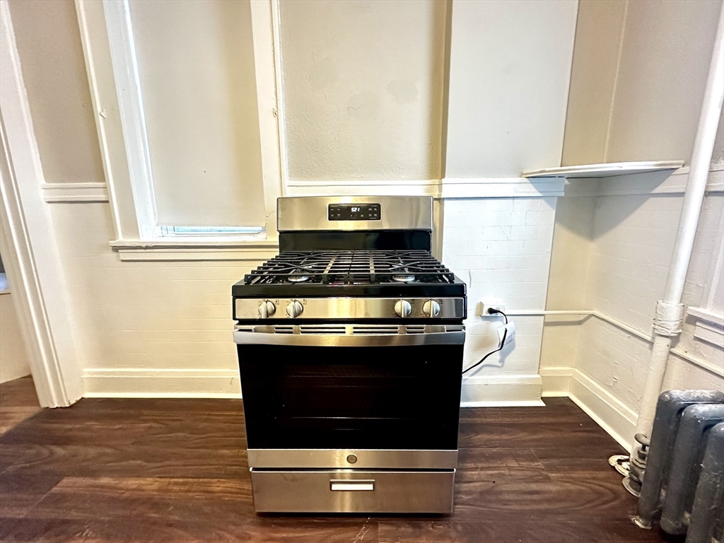 577 Pleasant Street, Unit 1L Holyoke, MA 01040 - Photo 5 of 24 a stove top oven sitting inside of a kitchen
