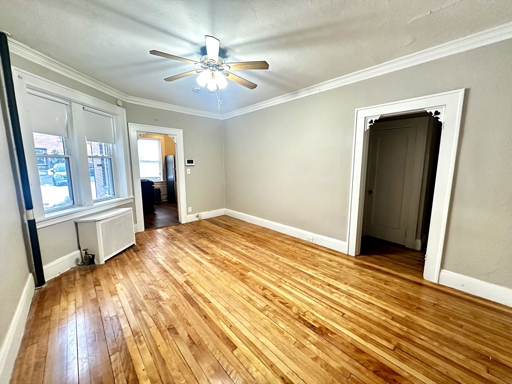 577 Pleasant Street, Unit 1L Holyoke, MA 01040 - Photo 7 of 24 a bedroom with a bed and a chandelier