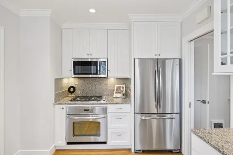 a kitchen with a sink cabinets and window