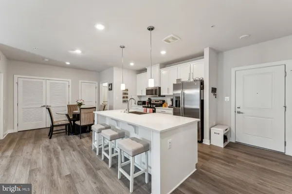 a large kitchen with a table and chairs