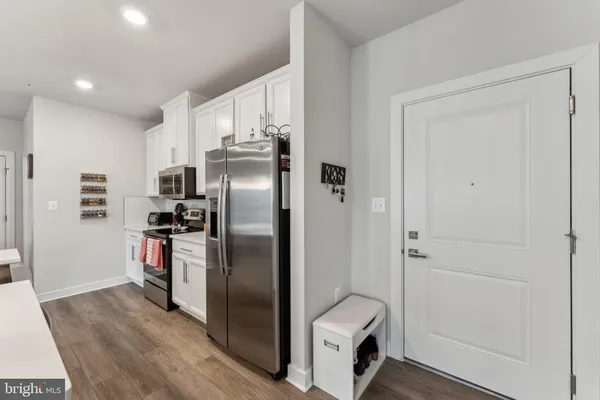a kitchen with stainless steel appliances a refrigerator and a stove top oven