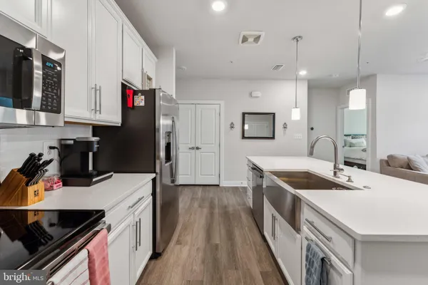 a kitchen with a sink stove and refrigerator