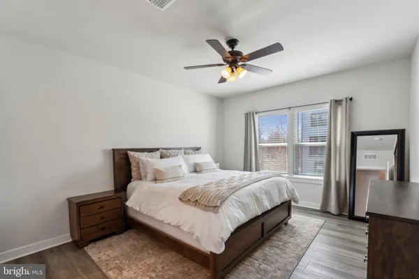 a bedroom with a large bed and a chandelier