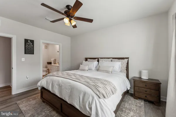 a bedroom with a bed and a ceiling fan