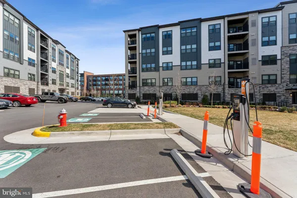 a view of tall buildings with cars parked