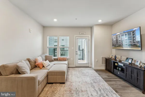 a living room with furniture and large window