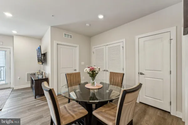 a view of a dining room with furniture and wooden floor