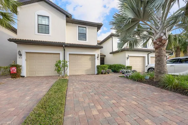 a front view of a house with a yard and a garage