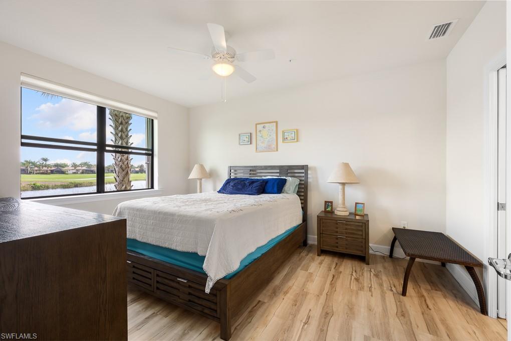 5698 Mayflower Way, Unit 403 Ave Maria, FL 34142 - Photo 15 of 27 a bedroom with a bed and a large window