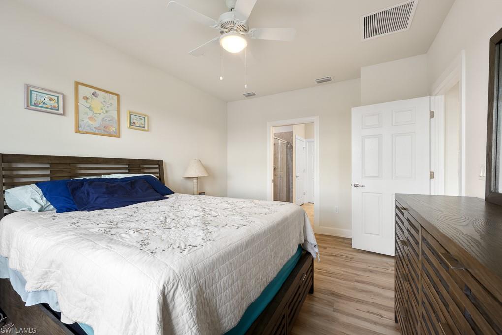 5698 Mayflower Way, Unit 403 Ave Maria, FL 34142 - Photo 16 of 27 a bedroom with a bed and wooden floor