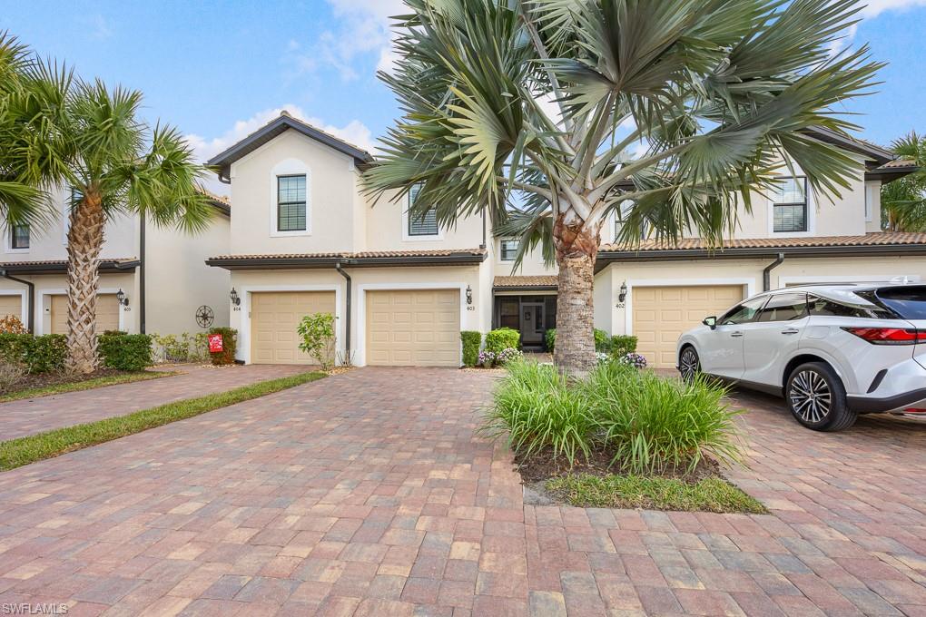 5698 Mayflower Way, Unit 403 Ave Maria, FL 34142 - Photo 22 of 27 a view of a car parked in front of house
