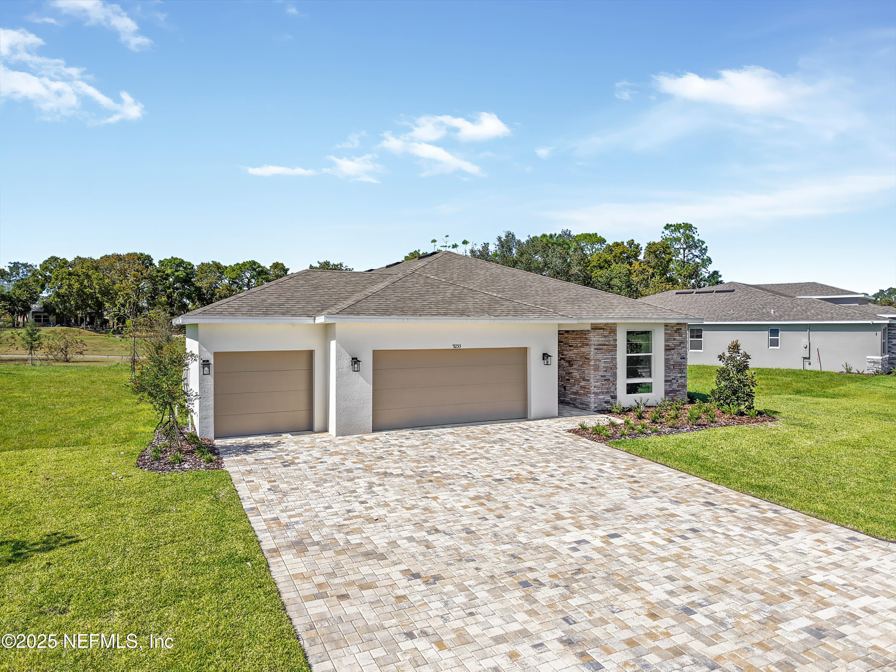 a front view of house with yard and lake