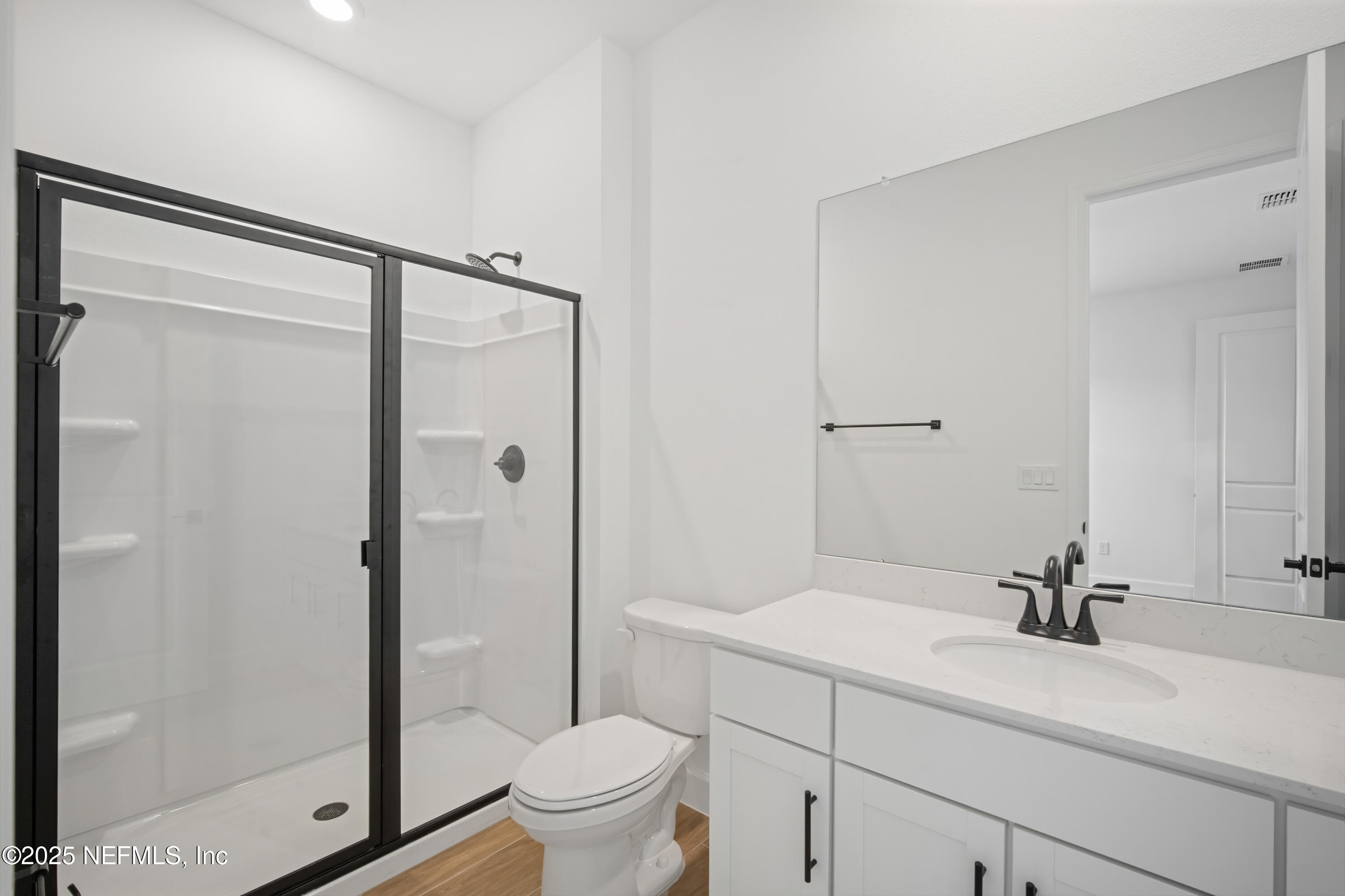 9253 Players Drive Weeki Wachee, FL 34613 - Photo 12 of 30 a bathroom with a shower sink vanity mirror and toilet