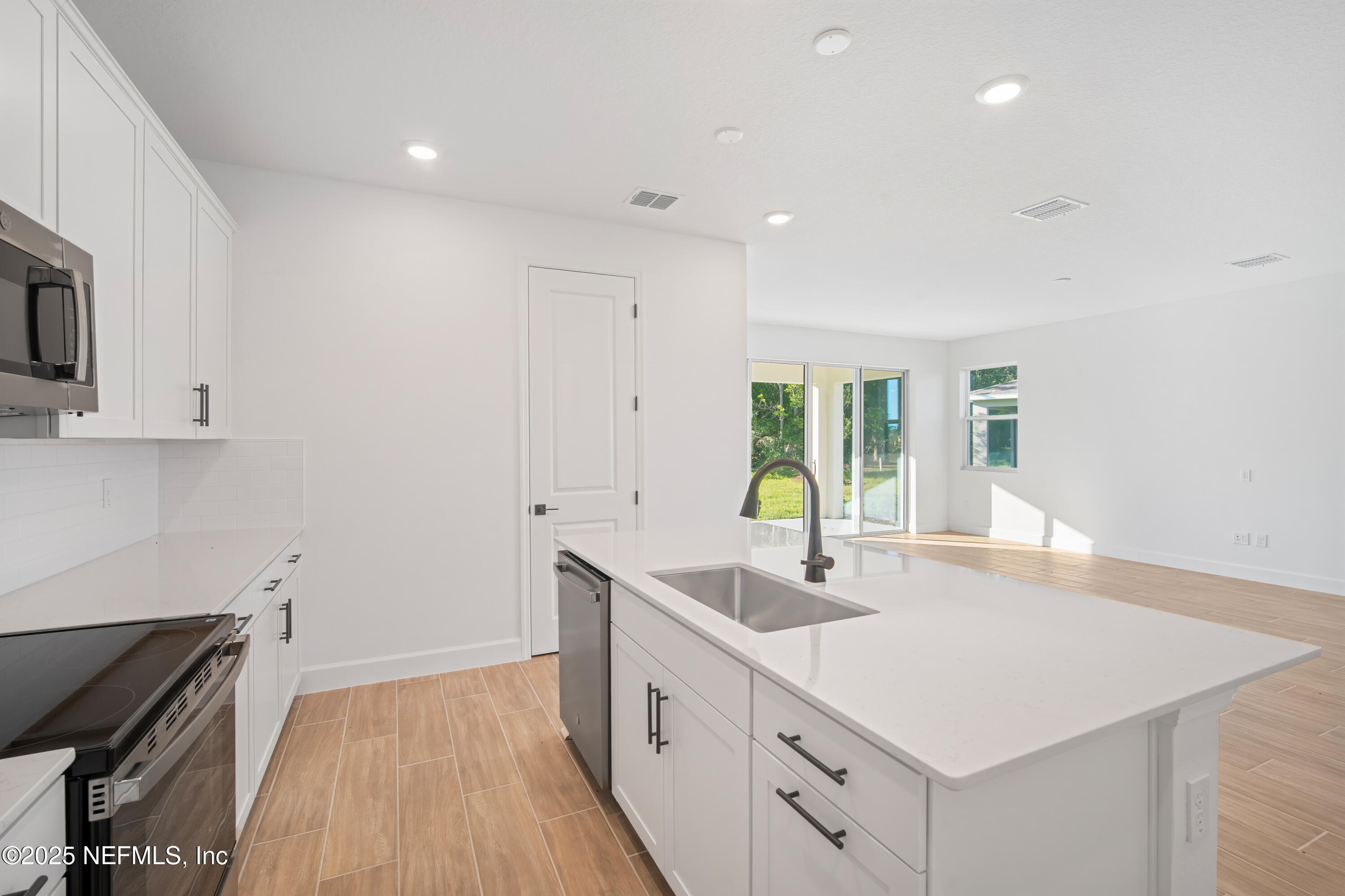 9253 Players Drive Weeki Wachee, FL 34613 - Photo 17 of 30 a kitchen with a sink stove and cabinets