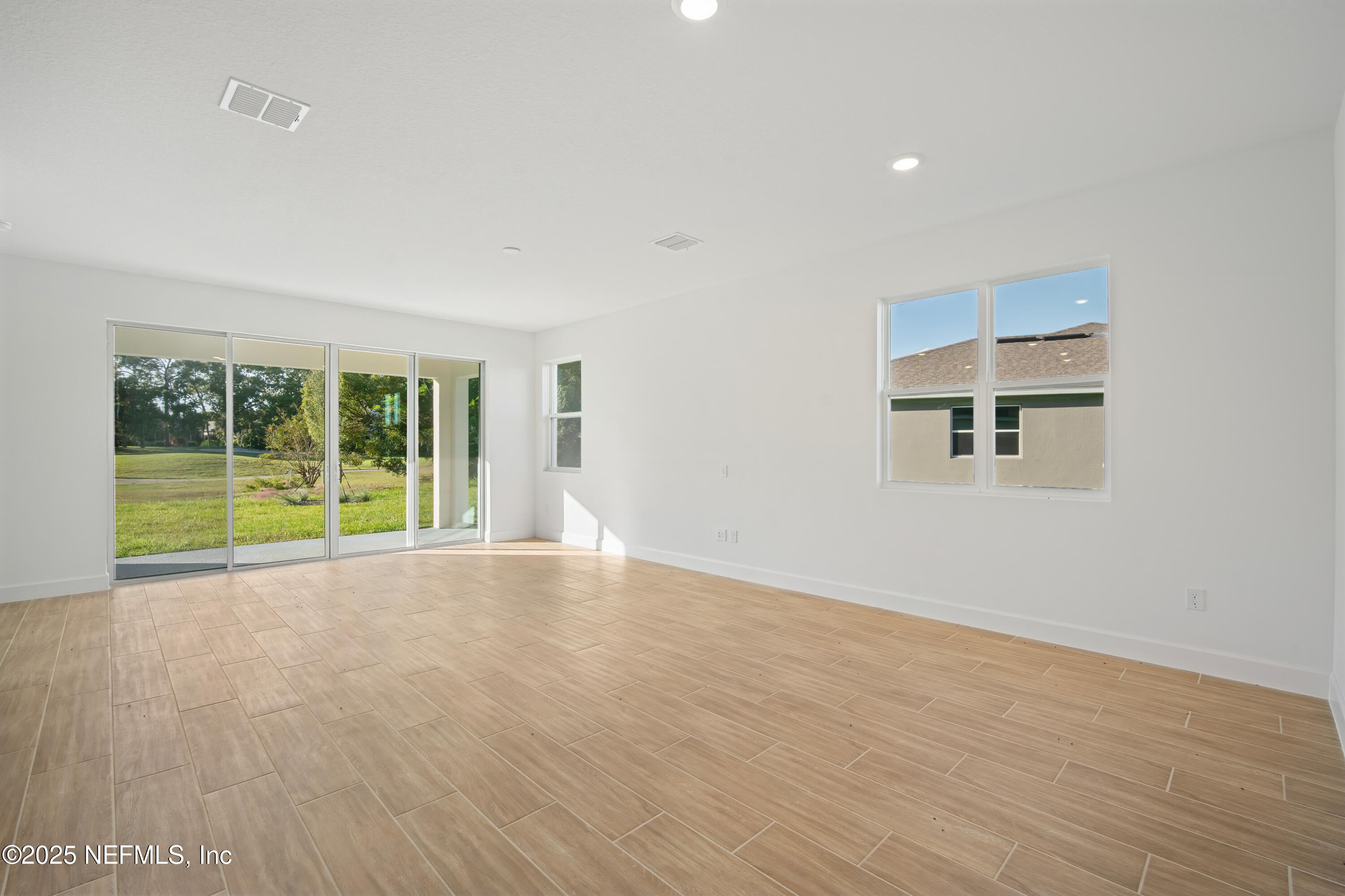 9253 Players Drive Weeki Wachee, FL 34613 - Photo 20 of 30 a view of an empty room with wooden floor and a window