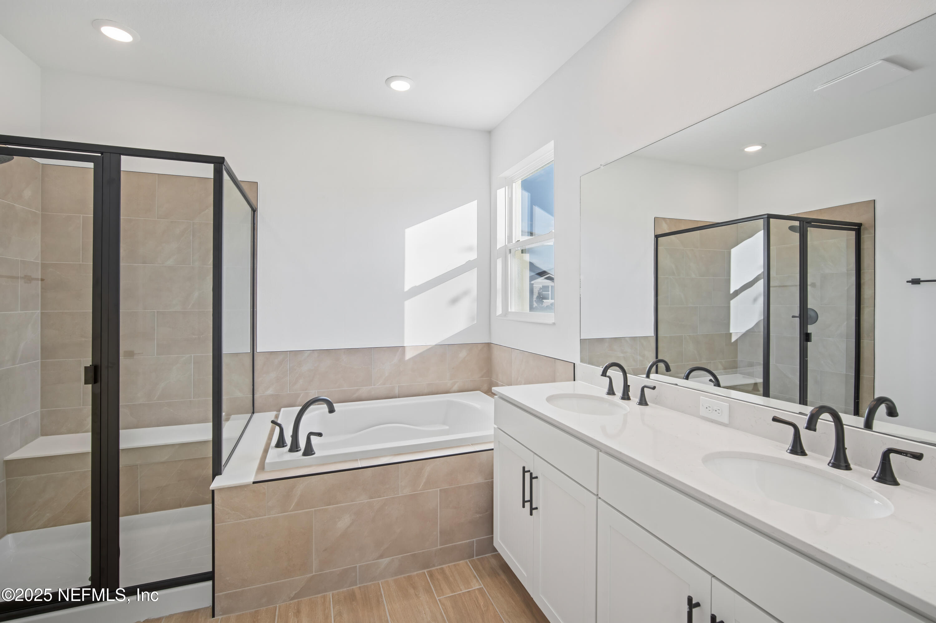 9253 Players Drive Weeki Wachee, FL 34613 - Photo 23 of 30 a bathroom with a double vanity sink mirror and bathtub