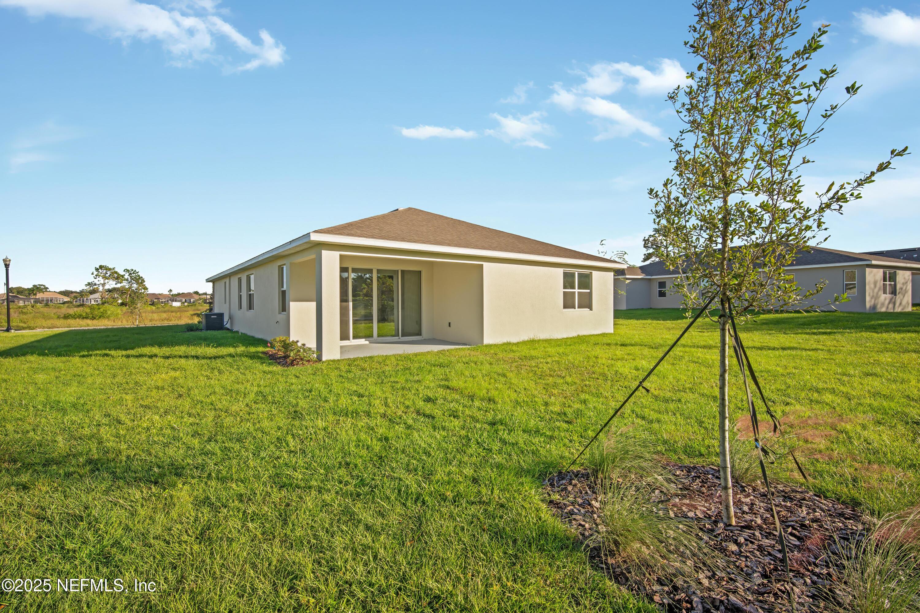 9253 Players Drive Weeki Wachee, FL 34613 - Photo 29 of 30 a view of a house with a backyard