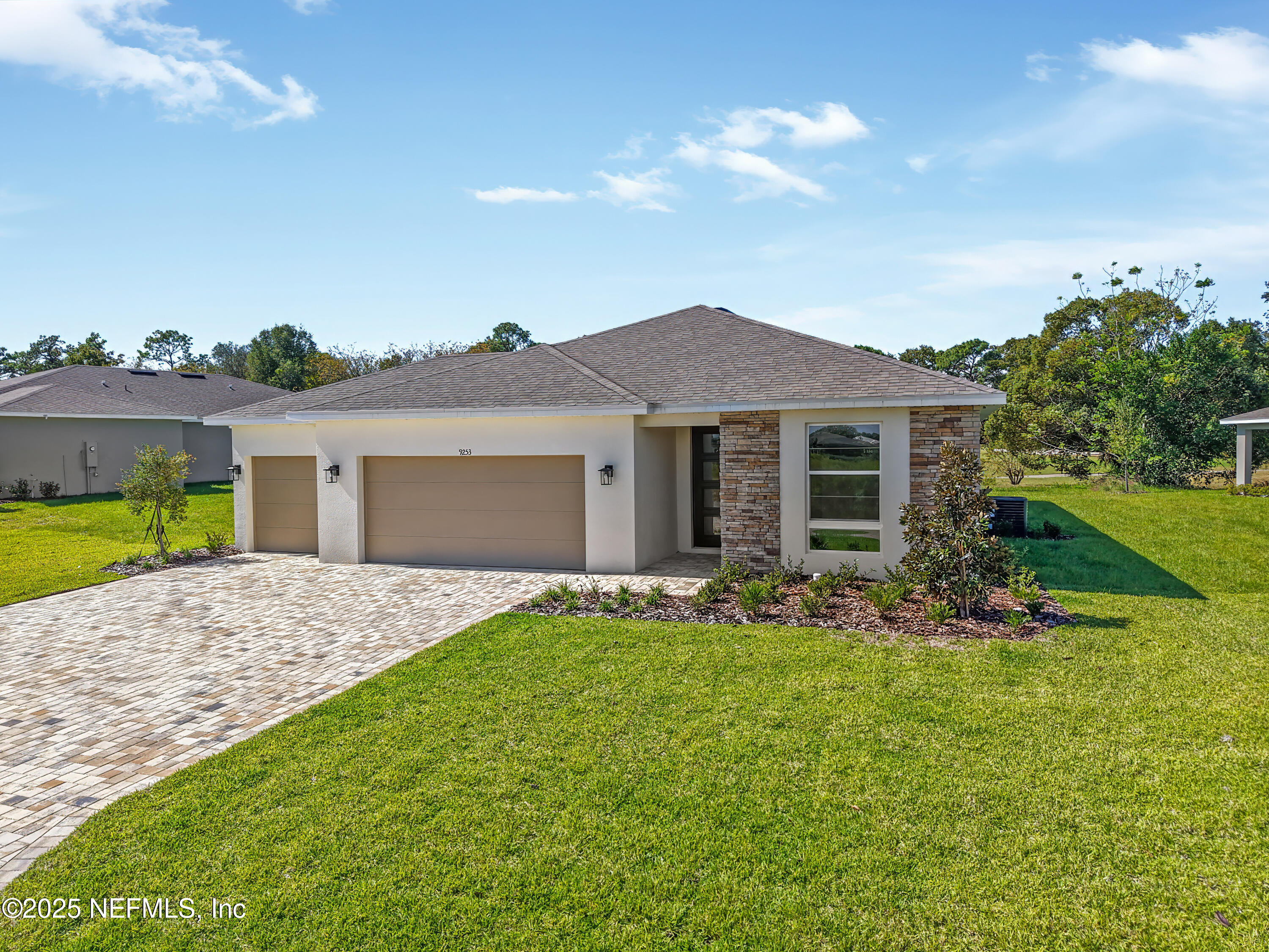 9253 Players Drive Weeki Wachee, FL 34613 - Photo 3 of 30 a front view of a house with a garden and yard