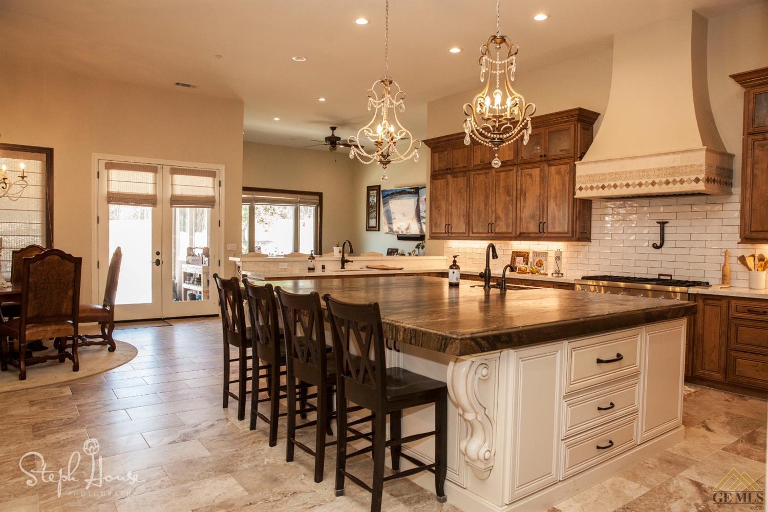 Undisclosed Address Arroyo Grande, CA 93420 - Photo 13 of 39 a kitchen with granite countertop a sink dining table and chairs