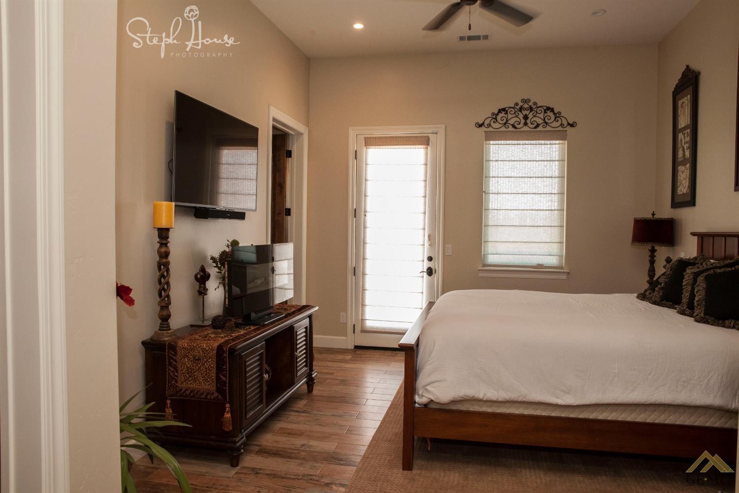 Undisclosed Address Arroyo Grande, CA 93420 - Photo 34 of 39 a bedroom with a bed and flat tv screen on the dresser