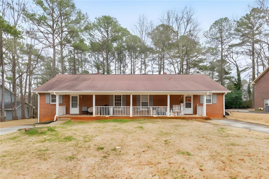 145 Hunters Lane Fayetteville, GA 30215 - Photo 1 of 1 a front view of a house with a yard and trees