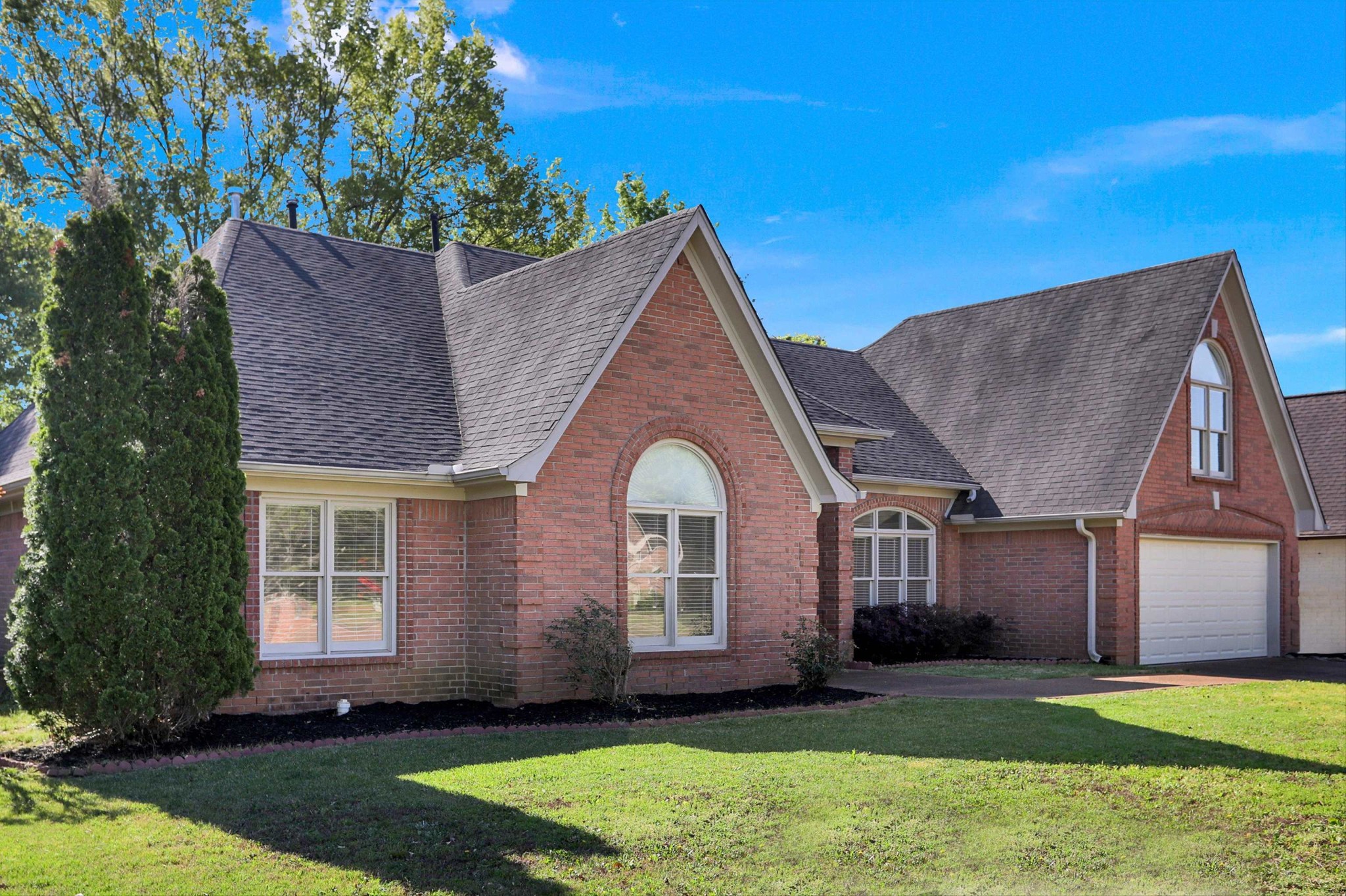 1130 Sugar Lane Collierville, TN 38017 - Photo 2 of 29 a front view of a house with a yard and garage
